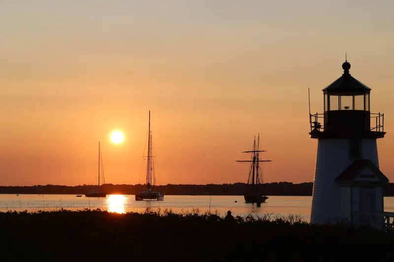 Brant Point Lighthouse and sailboats at sunrise on Nantucket